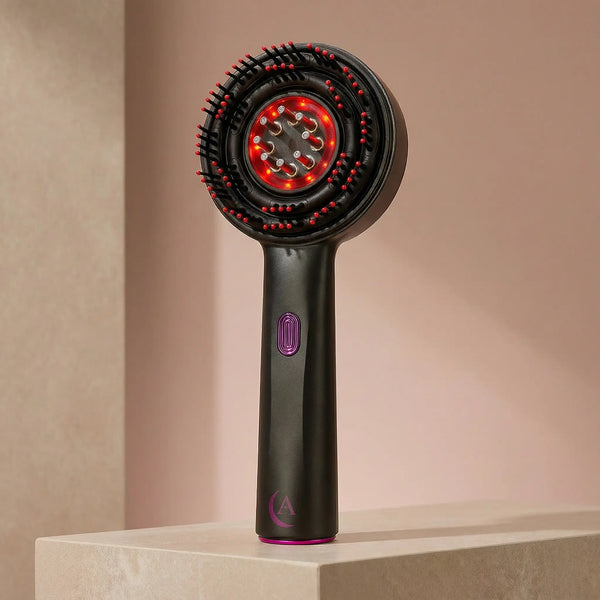 Black and magenta Solivine scalp massager in a beige background